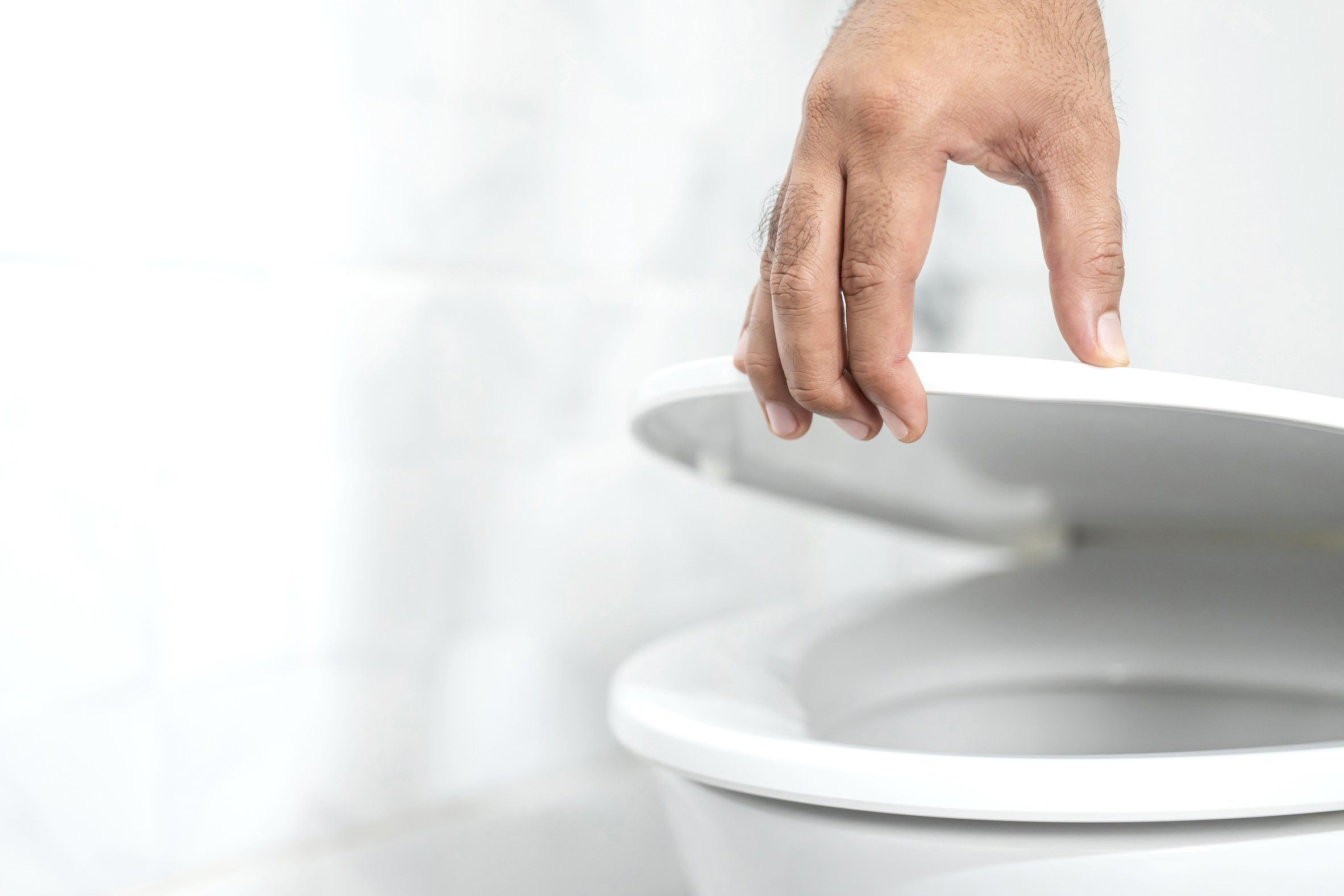 Male Hand Opening Toilet Bowl